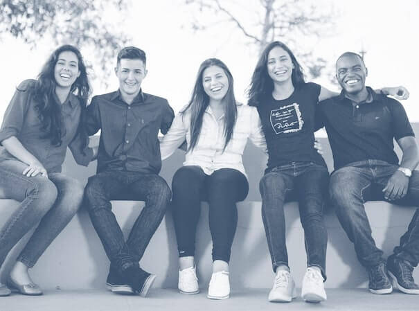 Coworkers sitting together and smiling outside. Coworkers sitting together and smiling outside.